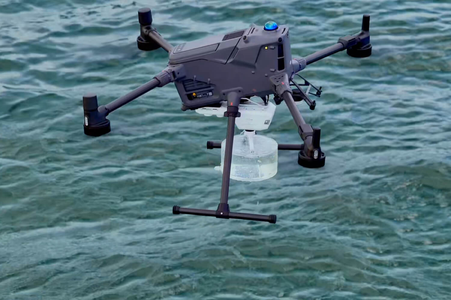 Enterprise drone carrying a specialist water sampling system over water