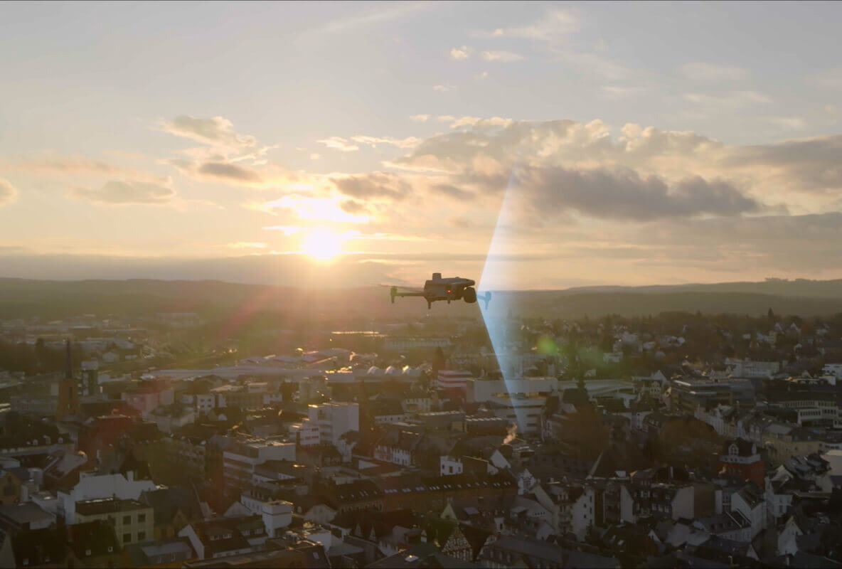 DJI promotional image of a Matrice 4 Series aircraft above an urban landscape at sunset