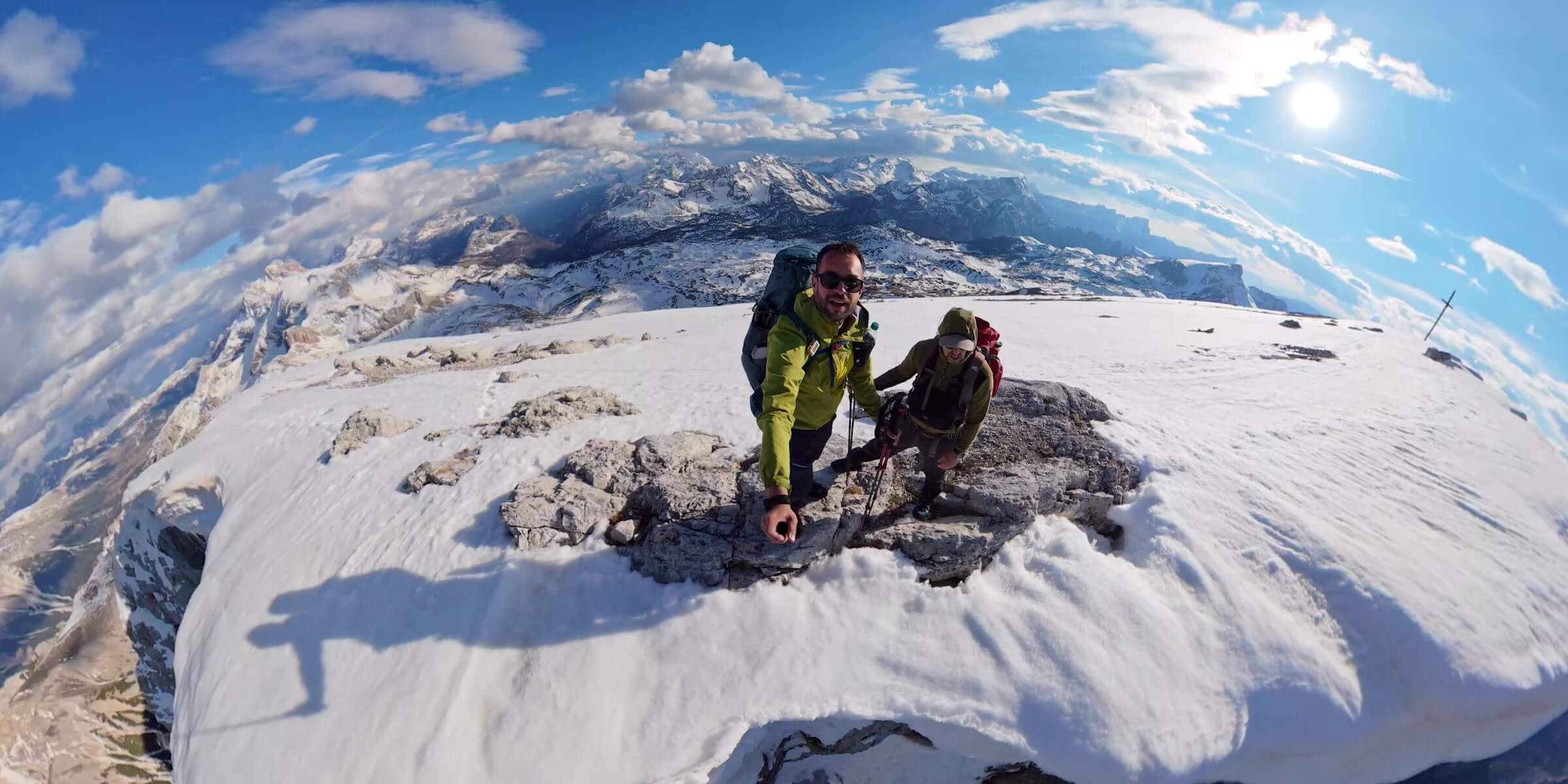 Hikers framed from an elevated DJI Osmo 360 II perspective in the mountains