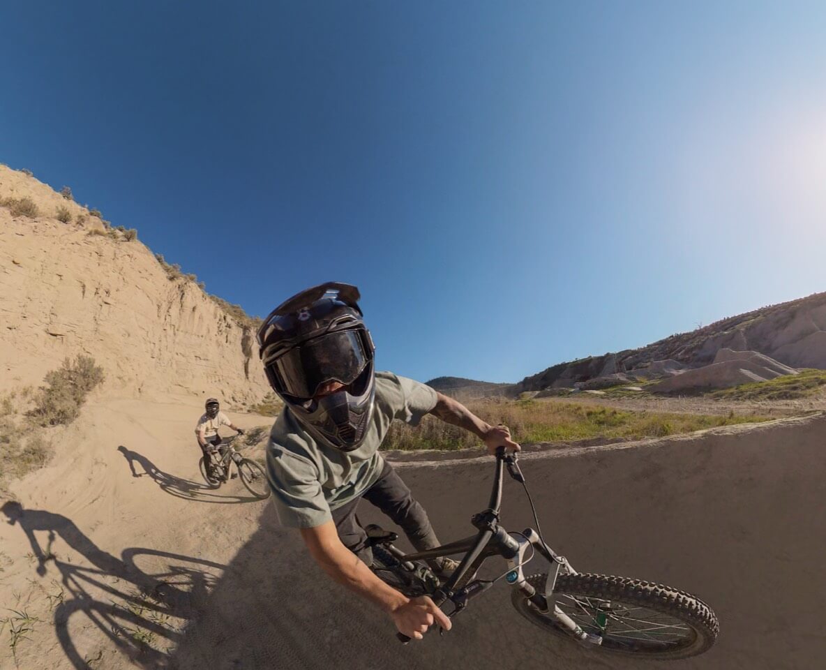 Mountain bikers in a reframed DJI Osmo 360 II cycling scene